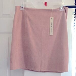 Mini faux suede pink skirt.